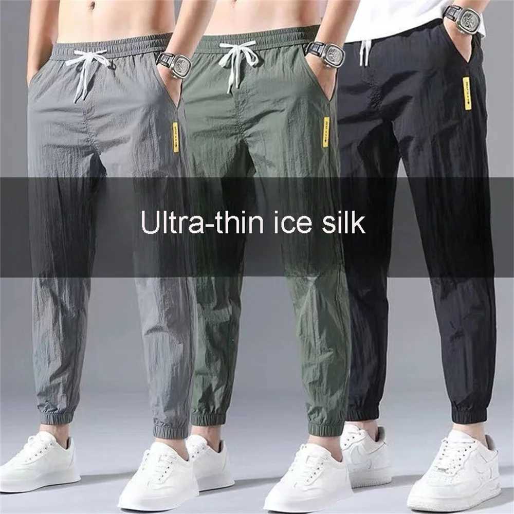 Mäns byxor Summer Mens Casual Sports Pants Polyester Korean Mens Ankle Tie Jogging Pants Breattable Solid Color Casual Pantsl2403