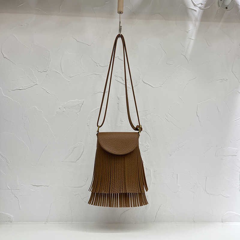 2022 Design Sense Koreansk mjukt läder Tofs Bucket Bag med Litchi-mönster Fashion Fried Street Mångsidig Skew Straddle Small Bag 230708