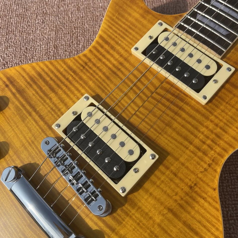 Vänster snedstreckelektriska gitarr citron lönn topp zebra pickups, en bit kroppshals, banden bindande, tune-o-matic bron