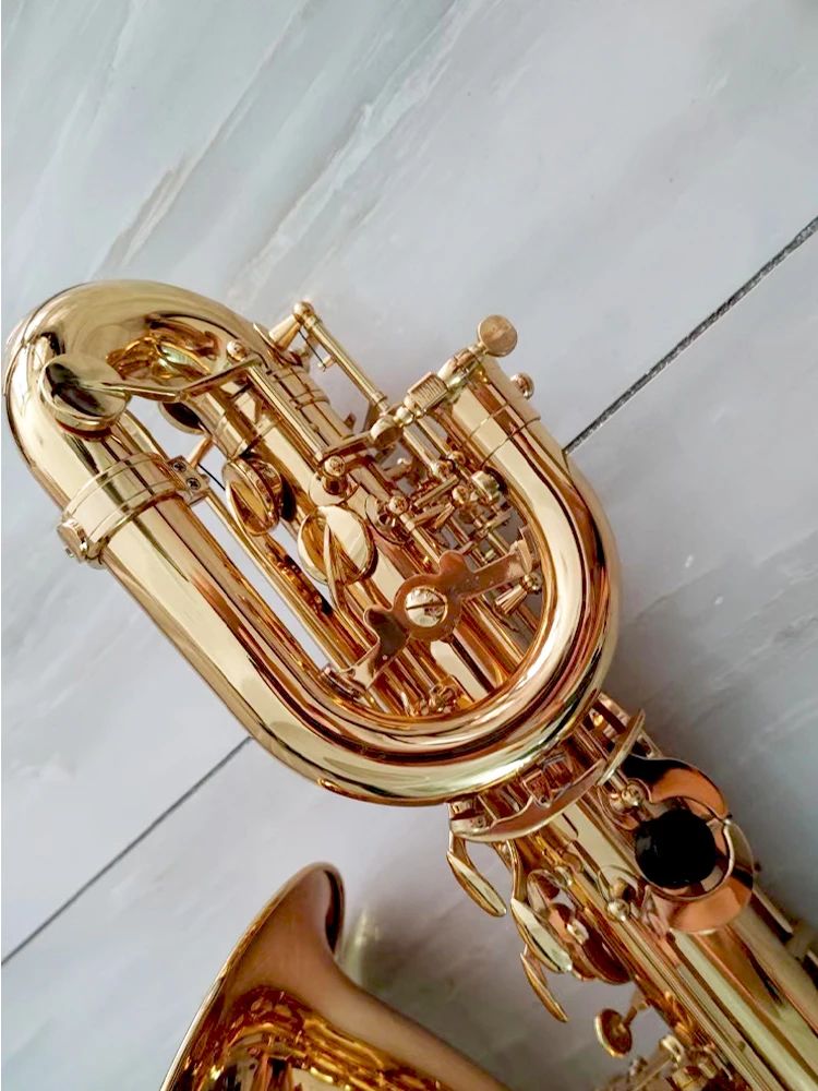 Goldenes professionelles Baritonsaxophon, flaches E-Tune-Upgrade, Doppelrippe, tiefes Gravurmuster, hochwertiges Klang-Jazzinstrument