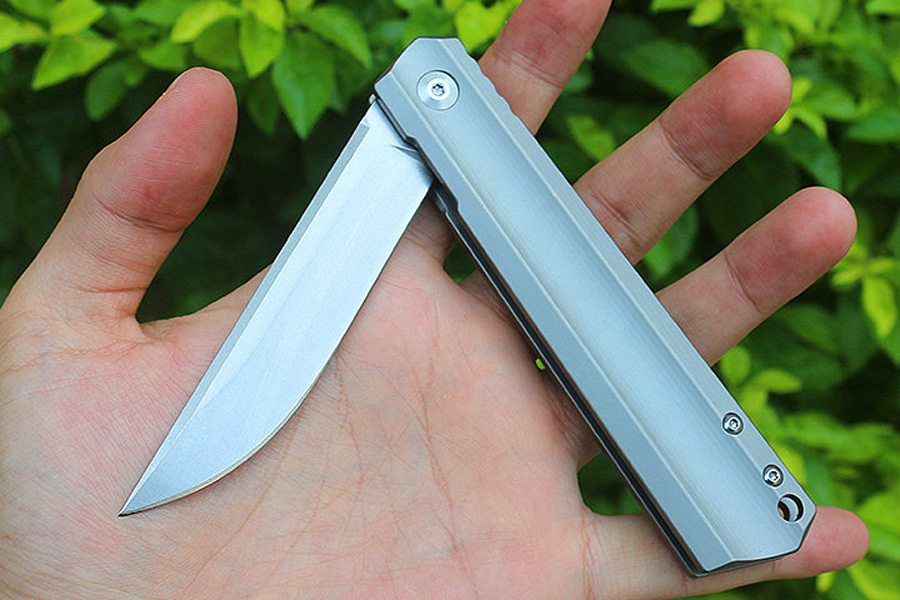 M6674 Titanlegering Flipper Folding Knife D2 Stone Wash Drop Point Blade CNC Finish Handle Boll Bearing EDC Pocket Folder Knives With Nylon Bag