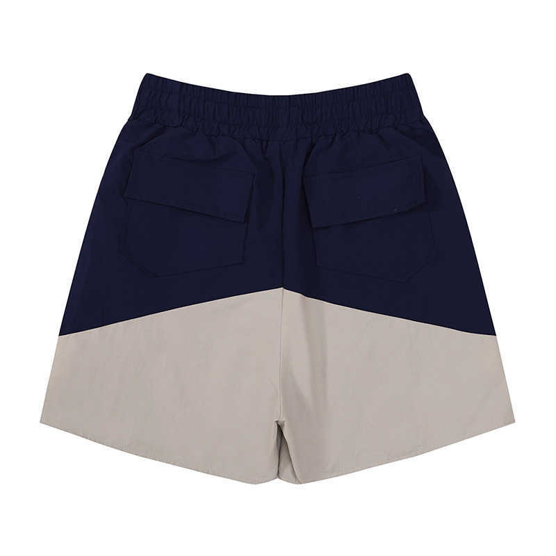 Shorts masculinos 2023 Novo short de retalhos da primavera no verão Homens Mulheres 1 1 Tags dentro de calças de zíper em malha vermelha azul preto G221214