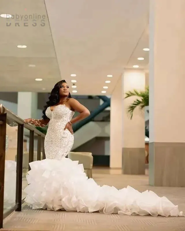 beaded ruffle wedding dress Beaded Corset Ball Gown with Tiered Ruffle Skirt Lotus Threads Bridal