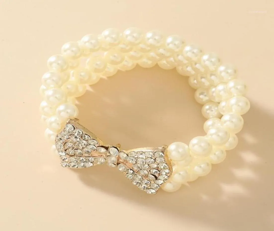 Nuovo braccialetto di perle imitazione multistrato barocco Bracciale in metallo con fiocco in oro con strass Braccialetti con ciondoli per accessori per gioielli da donna16592782