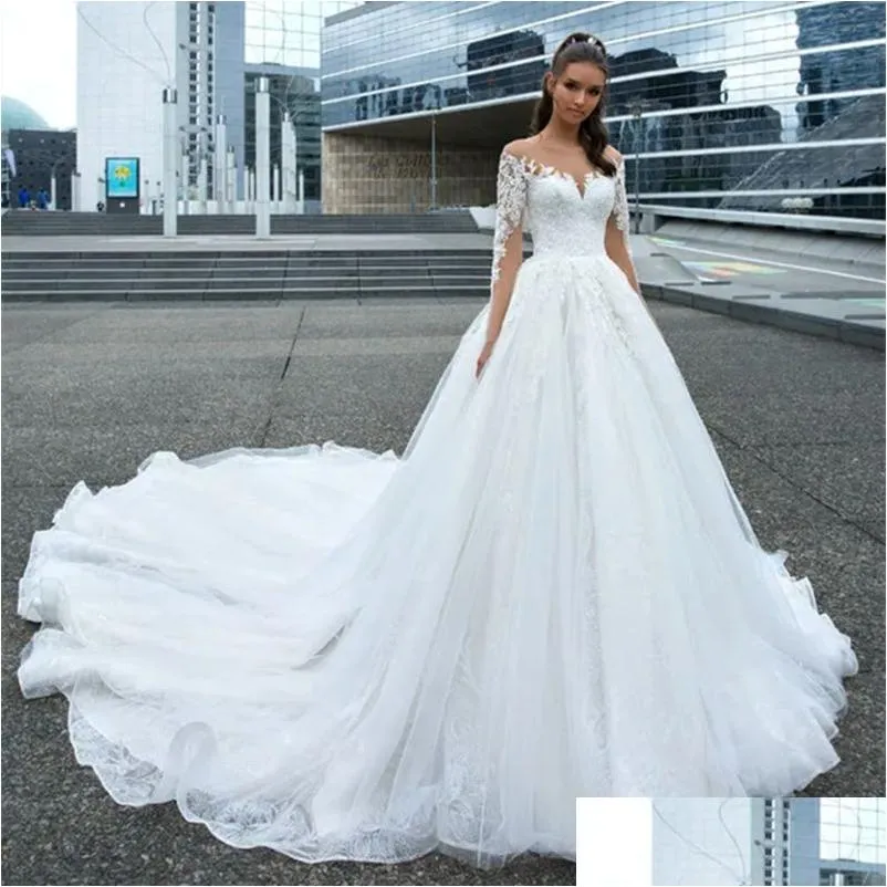 Abiti da sposa a trapezio Treno lungo Chiesa Abiti da sposa a linea per la sposa Maniche in pizzo Applicazioni Collo trasparente Elegante Avorio Tle Bridal G Otsv6