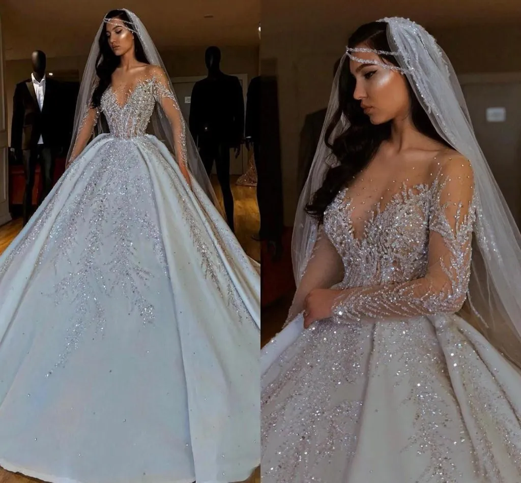 Lyxiga kristaller pärlor bollklänning bröllopsklänningar sexiga illusion långa ärmar saudiarabien dubai brudklänningar glitter paljett spets vestido de novia al9595