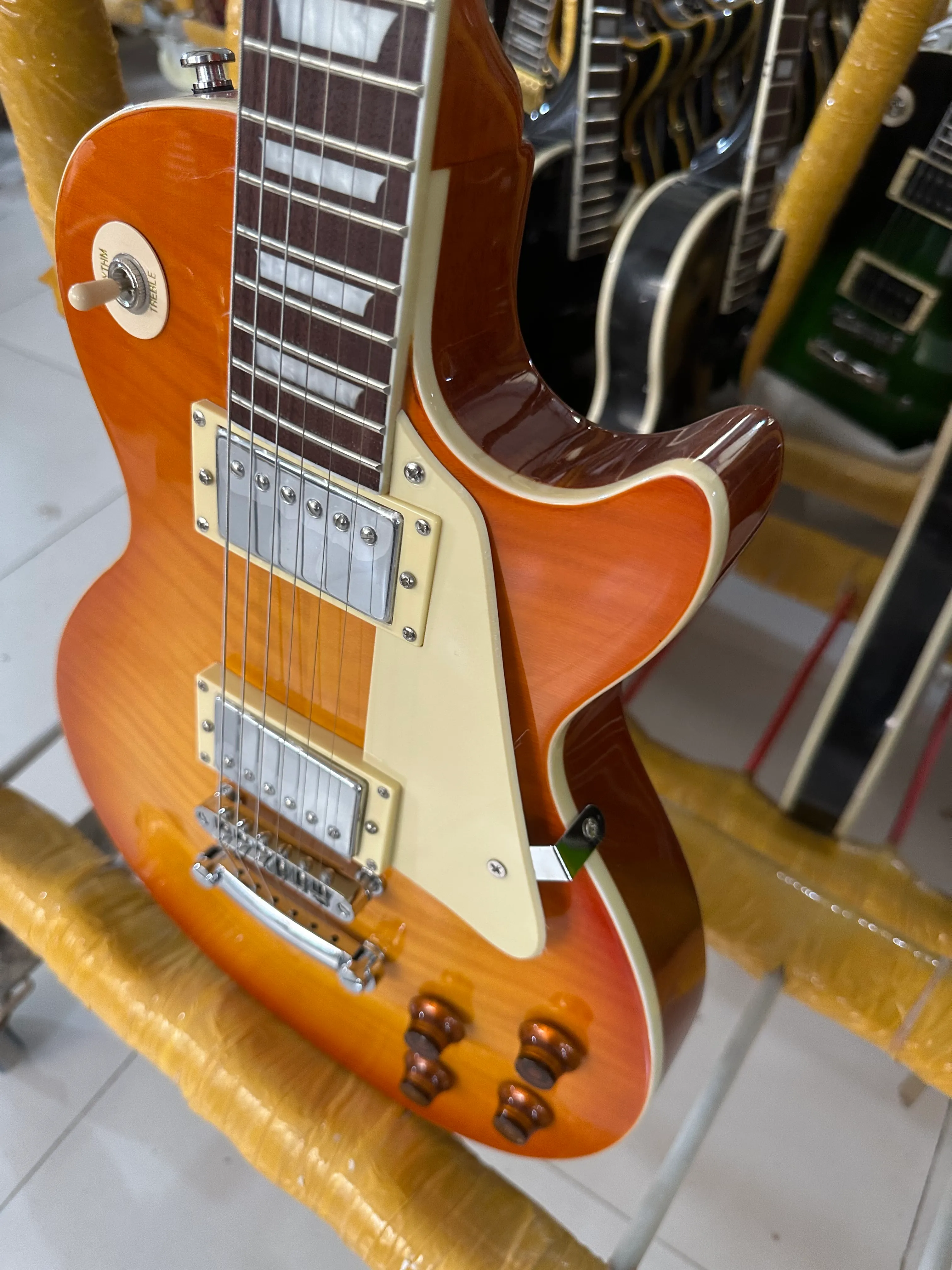 Standard electric guitar, orange honey gradient, bright light, silver accessories and tuner, available