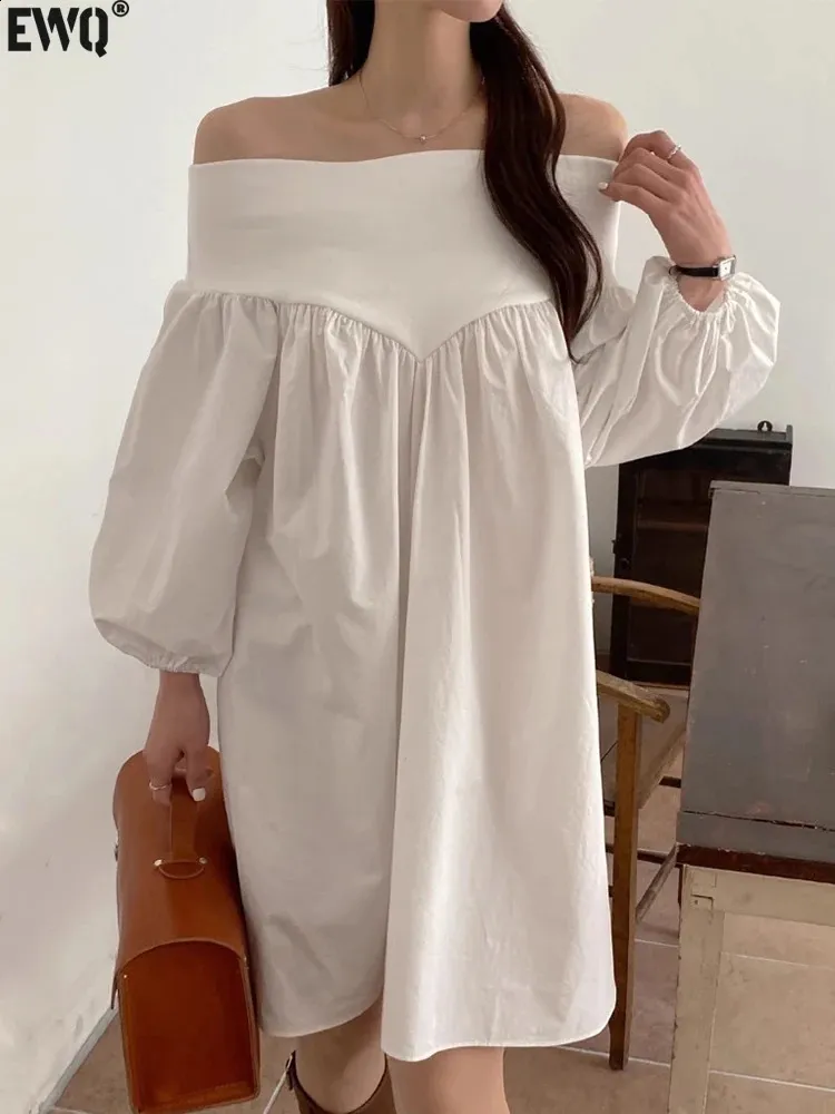 Elegant White Dress with Loose Folds and Brown Purse