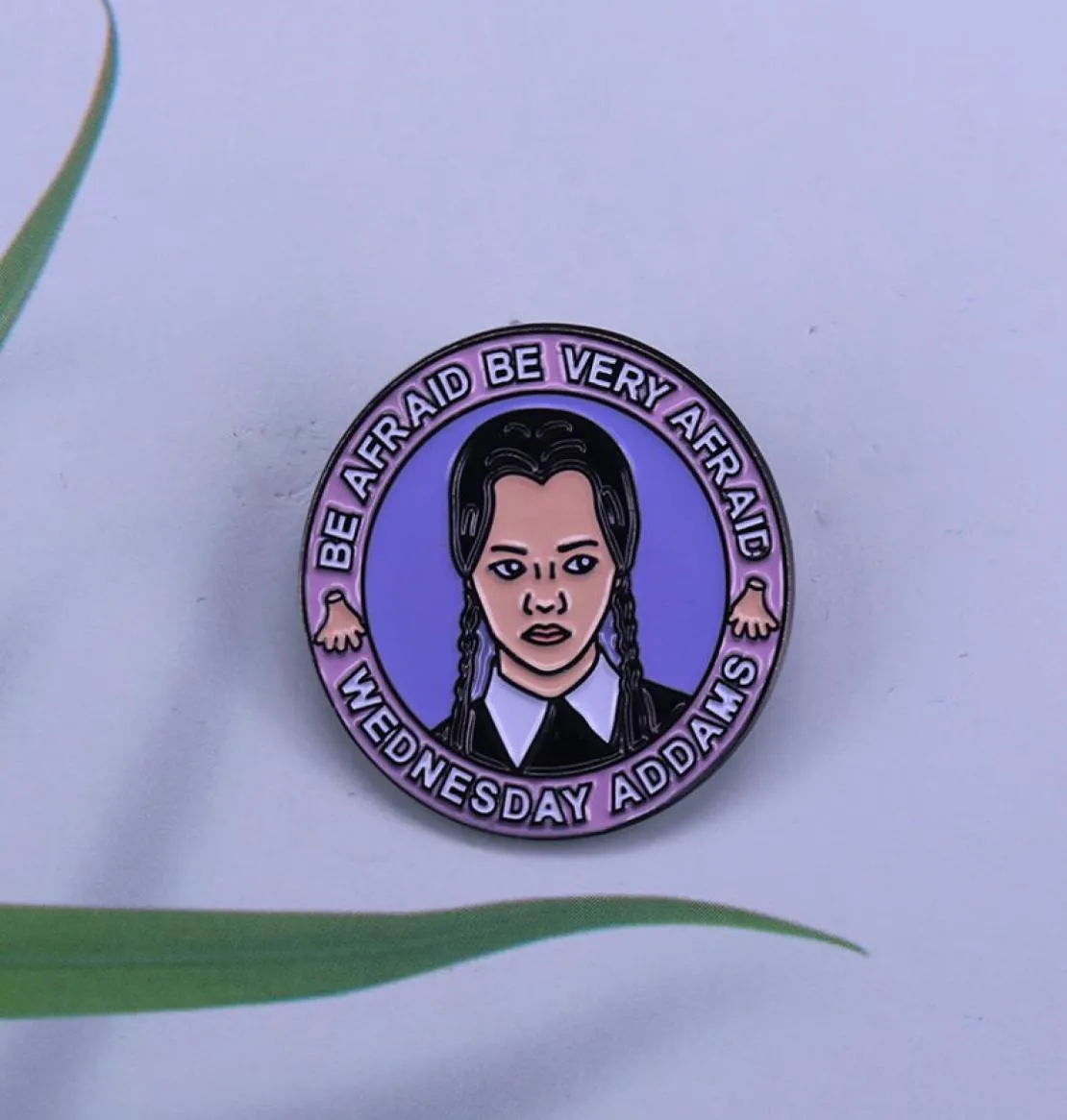 Grumpy Wednesday Adams on a circular enamel pin witchy and gothic babe kickass brooch collection8715338