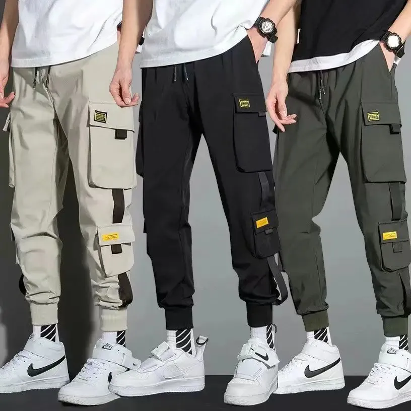 Cienkie streetwearne spodni Mężczyźni Wstążki haremowe spodnie do joggingu samce Slim Fit Spring Cargo Spodnie Multi-Pockets Women Spodni Jx1 240228