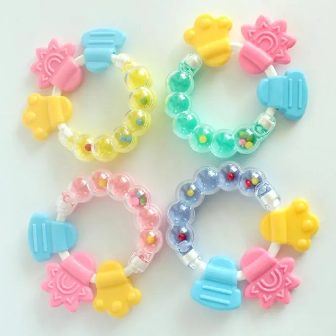 Sonaglino per bambini colla per denti sonaglio a mano per bambini lenitivo anello per morso in silicone combinazione smerigliatrice per denti all'ingrosso