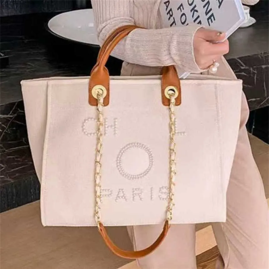 % 70 Fabrika Çıkışı Kapalı Kadınların El Tuval Plaj Çantası Tote Çanta Klasik Büyük Sırt Çantaları Kapasite Küçük Zincir Paketleri Büyük Crossbody MB27 Satışta