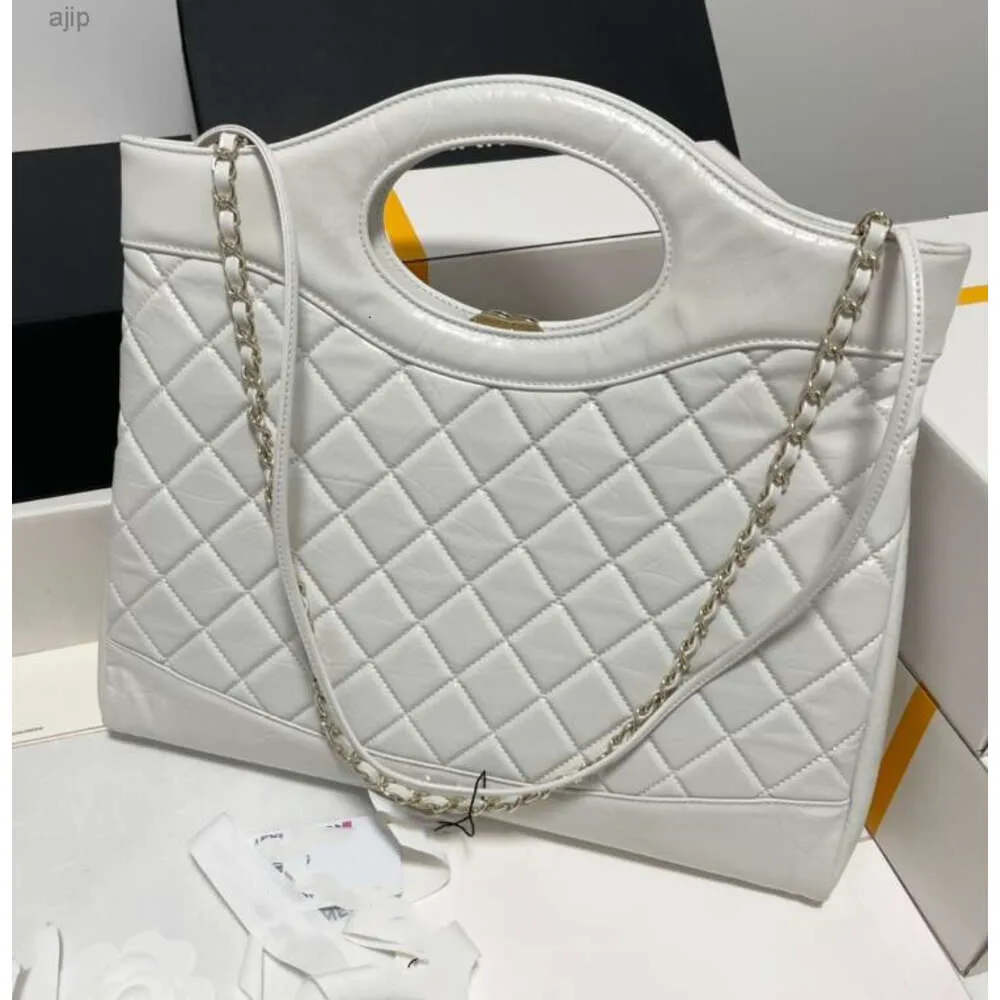 2024 Designer de luxo Moda Bolsas de couro de alta qualidade Bolsa de compras maxi de couro de couro real colaborou bolsas de bolsa de ombro de ombro de ombro preto com bolsas de ouro