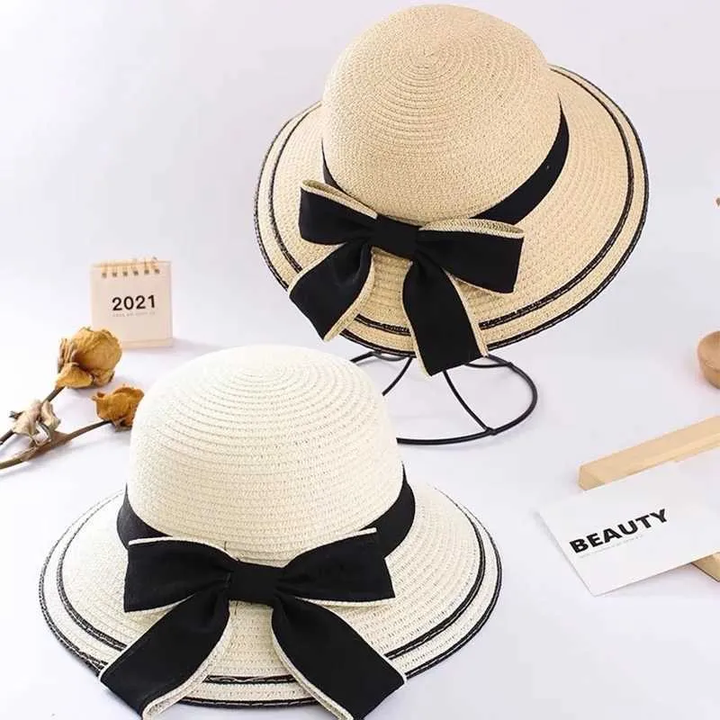 Breda randen hattar hink hattar Panama Womens strandstrå hatt med stor randen solskade och fashionabla utomhusbåge sommarhatt h65 J240325