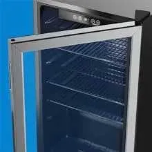 A Beverage Cooler with an Open Glass Door on a Blue Background