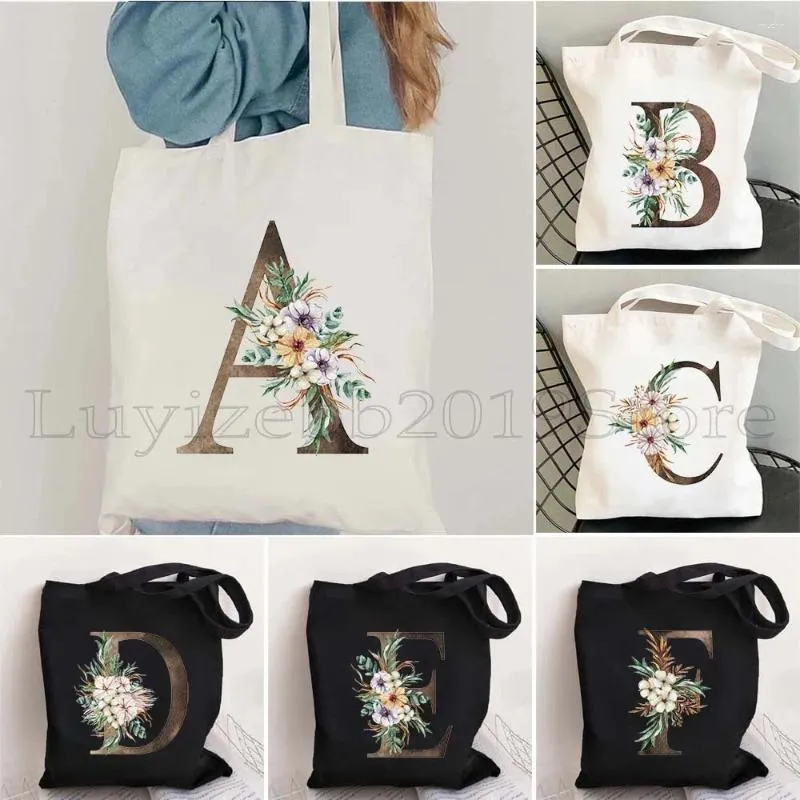 Borsa a tracolla in tela con stampa della lettera iniziale dell'alfabeto dorato con coulisse, motivo floreale ad acquerello, fiore da matrimonio, borsa a tracolla Harajuku