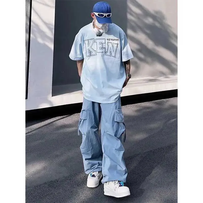 Pantalon masculin American Atmosphère Street Blue mâle dépasse la tendance du hip-hop d'été masculin et féminine entièrement assorti des pantalons décontractés J240507