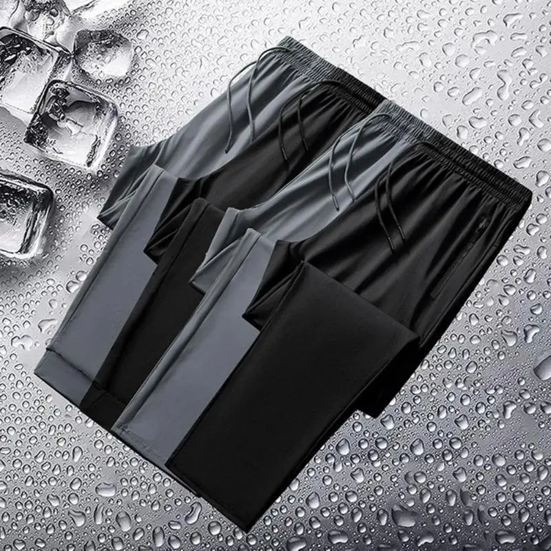 Pantalon masculin couleur solide à séchage à séchage sport en soie avec des poches côté jambe larges cordon de taille élastique pour l'entraînement au gymnase