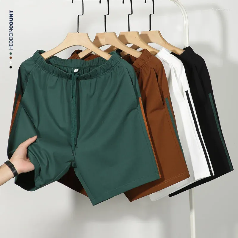 Ligne de vêtements pour hommes avec des rayures contrastées Sport Capris Pantalon court de basket-ball de basket-ball lâche et respirant