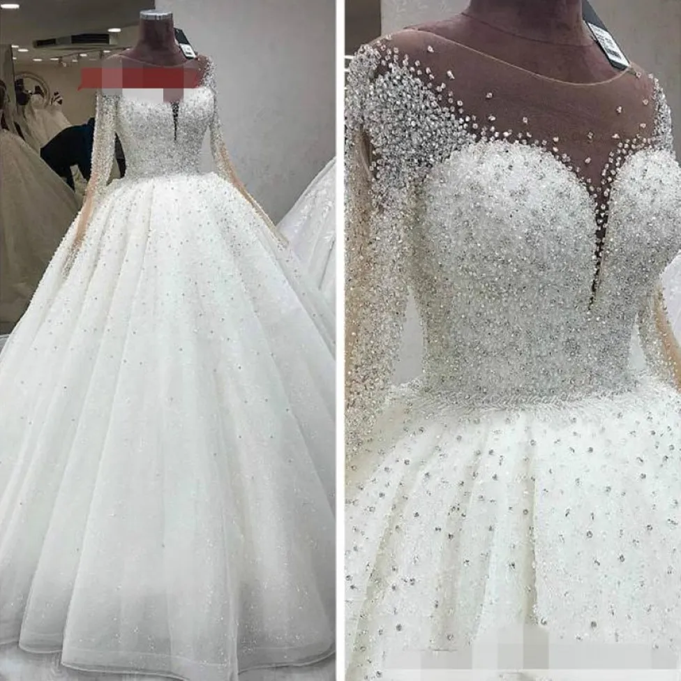 2022 Vestidos de noiva de cristal de contas luxuosos Princesa com ilusão de mangas compridas Tulle branco decote de decote oco com bola de costas 227g