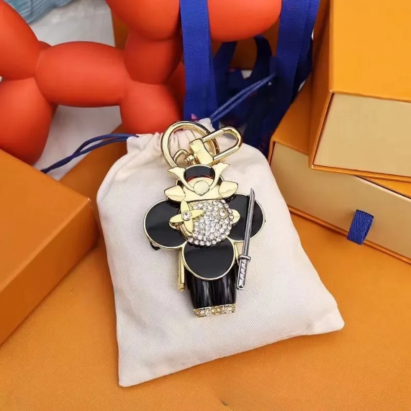 Projektant Luksusowy brelok Blak Luksusowy żeńska kobieta brązowa skórzana torebka torebka torebka smycza złota akcesoria na brelok do klucza brelokowego z literami top118