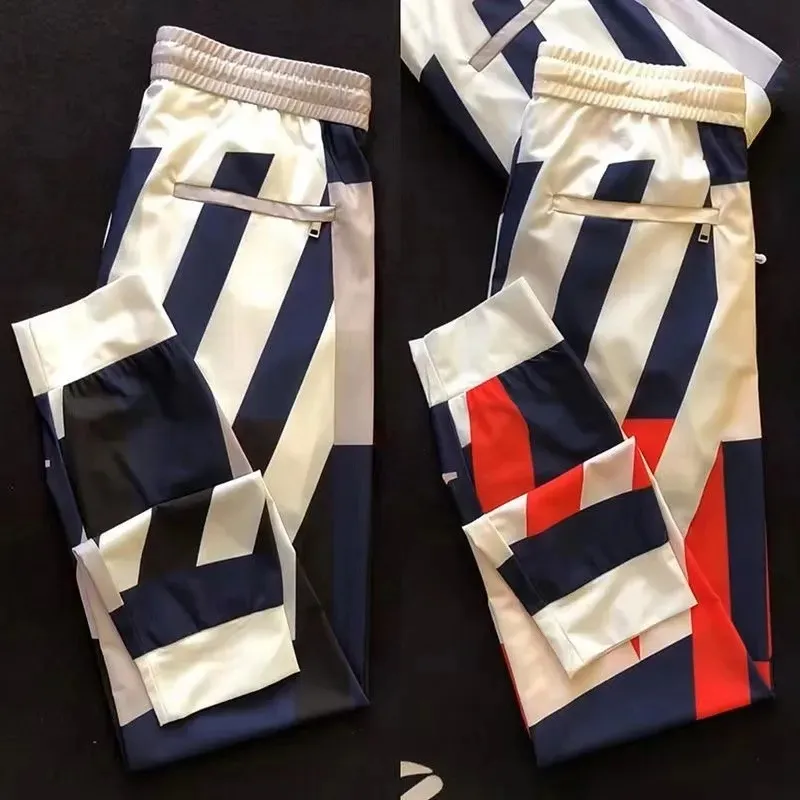 Été nouveau pantalon décontracté coloré pour les poches à la mode pour hommes, leggings à fermeture éclair, couleur de gâteau polyvalente pantalon de sport élastique rapide