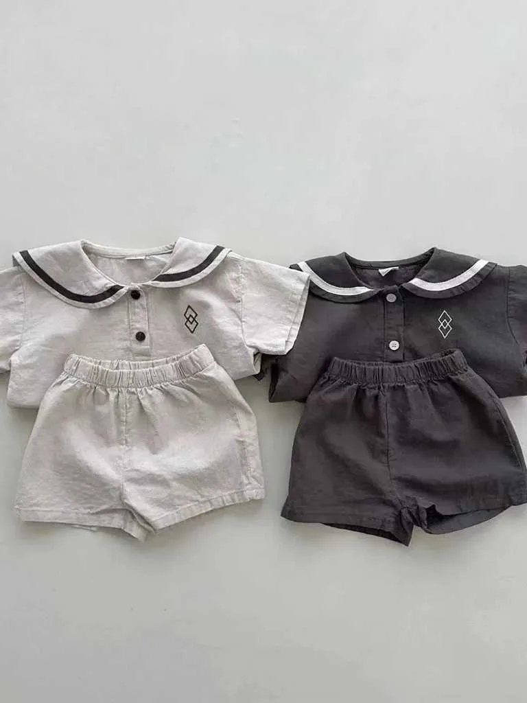 Kleidungssets 2024 Sommer Neues Baby Kurzärmeler Kleidungsstücke und Mädchen lässige Shorts -Shorts Set Vorschule Navy Blue Ausschnitt Geometrisches Muster Setl240513