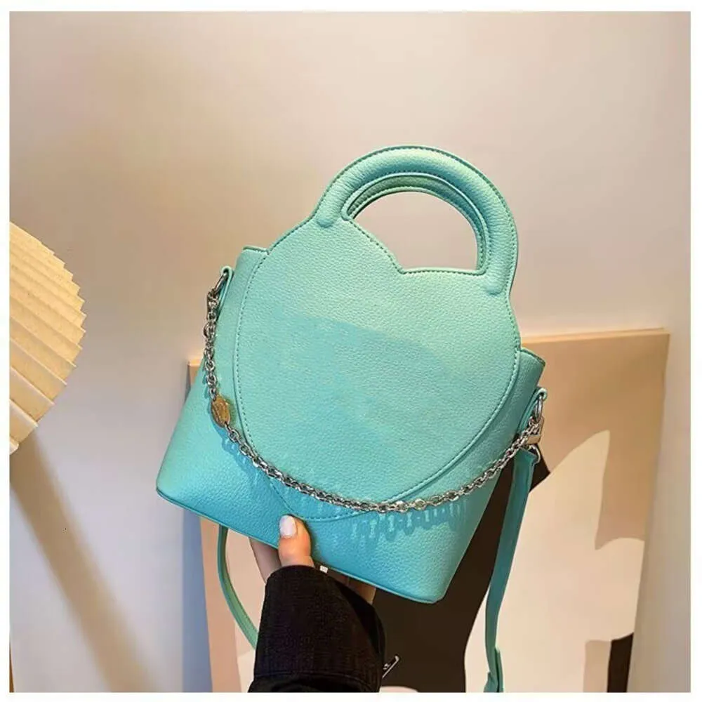 Véritable sac en peau de vache seau femmes une épaule bandoulière sacs à main de créateur Litchi chaîne de grain décoration fourre-tout de luxe shopping sacs à main en cuir sac à dos