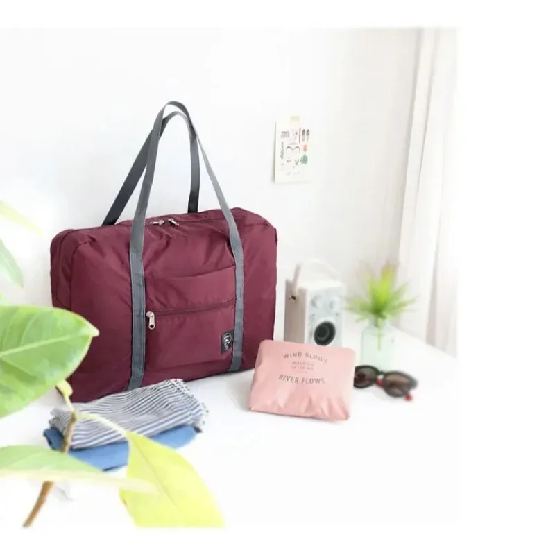 Ny 2024 Stora kapacitet förvaringspåsar Foldbar nylon resväska kläder arrangörer unisex bagage kvinnor vattentäta handväskor män resväska -