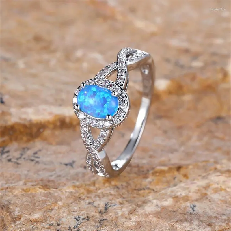 Bröllopsringar Små oval stenblå Opal Ring White Zircon Hollow Infinity Engagement for Women Trendy Silver Color Band smycken