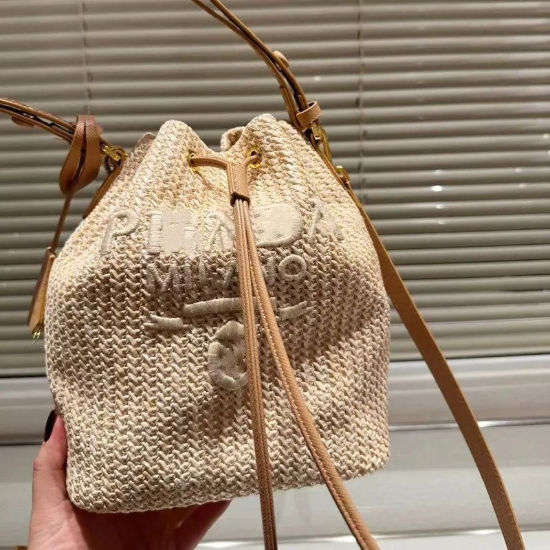 High-end designer bag bucket bag leisure straw woven material leisure sports bag can be carried across the body 