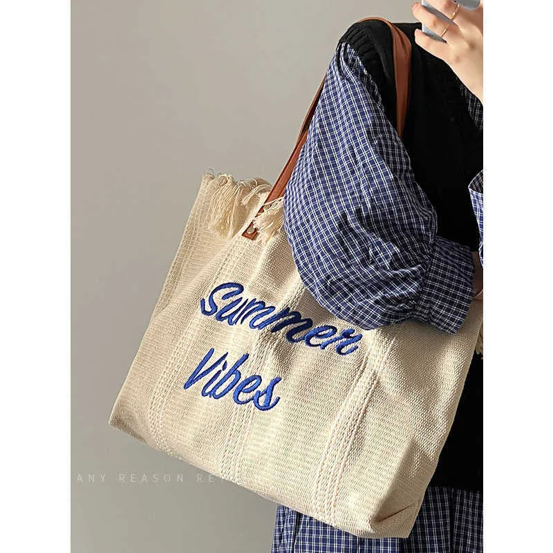 Women's 2023 New Letter Tassel Canvas Bag Women's Large Capacity Simplified One Shoulder Tote Bag 240408