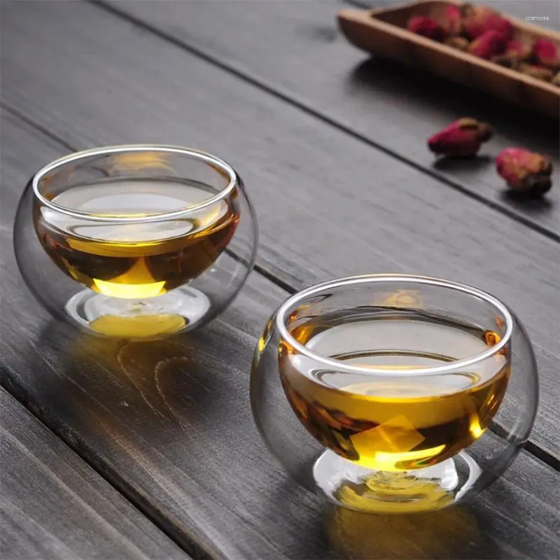 Tasses Saucers buvant un thé à tas de thé à la chaleur à double paroi transparente.