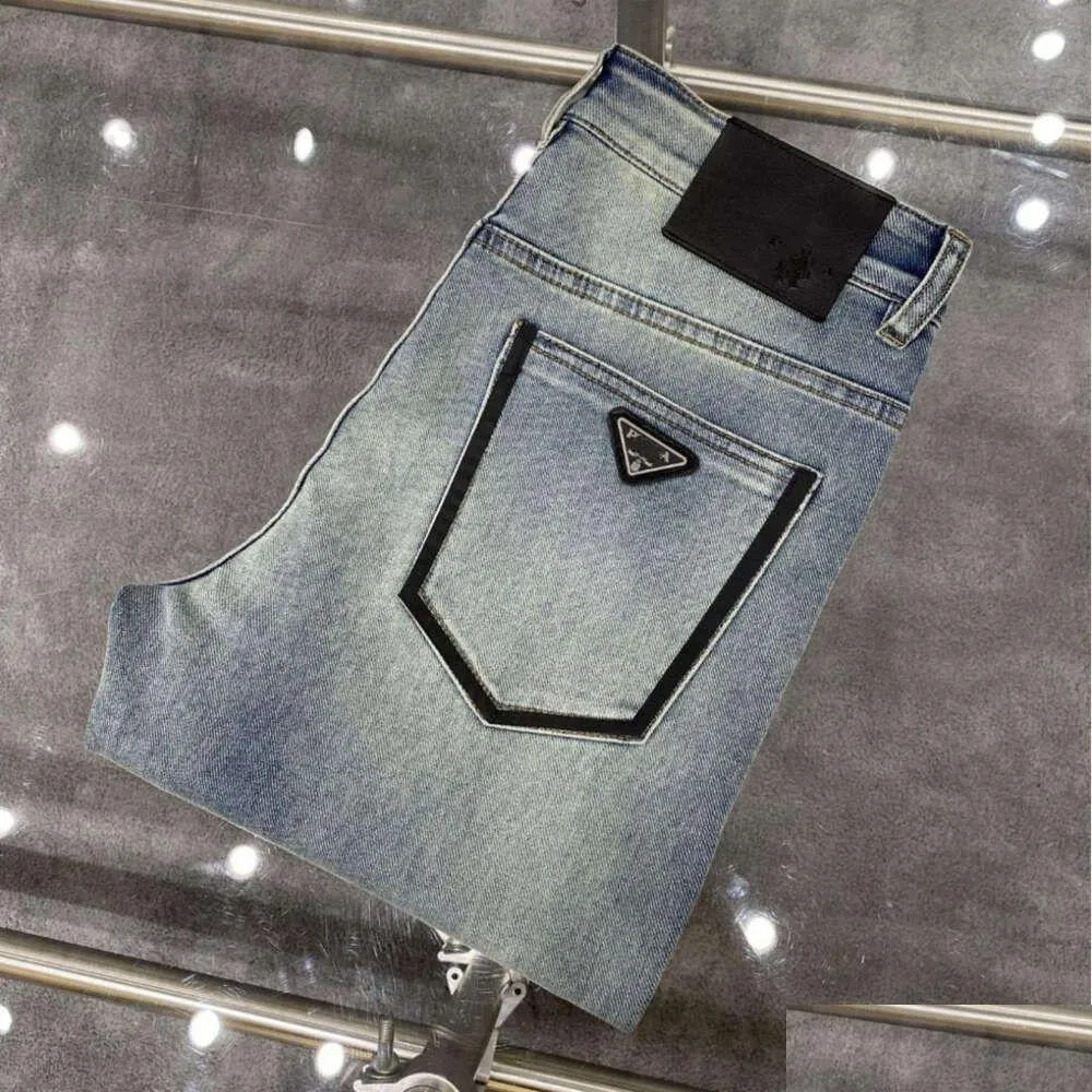 Jeans pour femmes Pantalons de créateurs pour hommes de haute qualité Men Slim Small Coton Coton Contrôle décontracté pantalon Fashiona Triangle Logo Lettre graphique OT14M