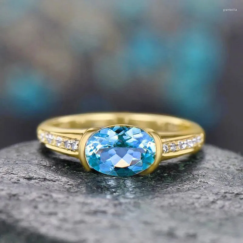Med sidogonter köpa 2024 trendiga guldfärg kvinnor bröllopsring lyxig blå kristall zirkoniume kvinnliga party smycken dropship