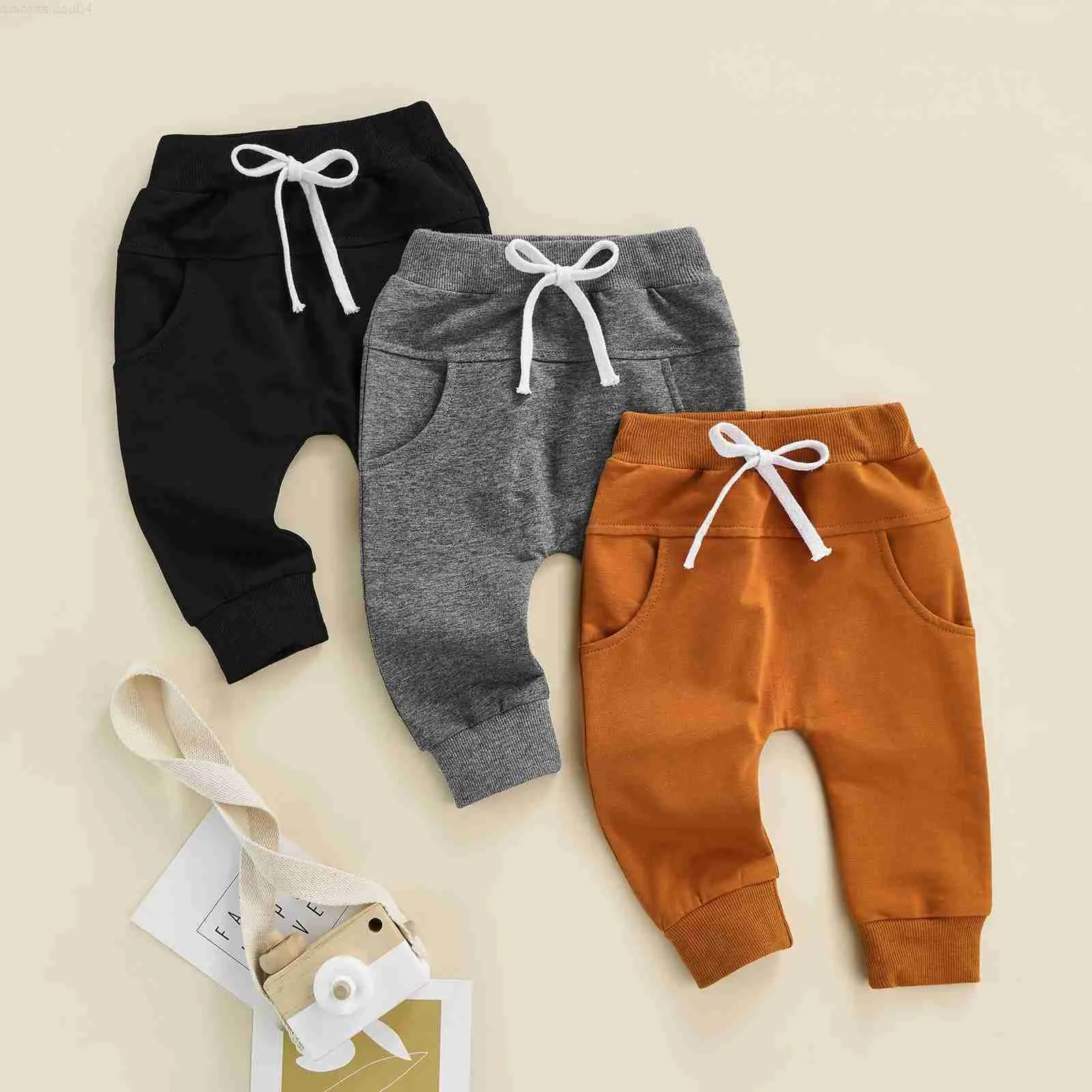 Byxor för byxor för nyfödda pojkar och flickor med en justerbar elastisk midja och en avslappnad stil som är lös och lämplig för byxor med en längd på 0-3tl2404