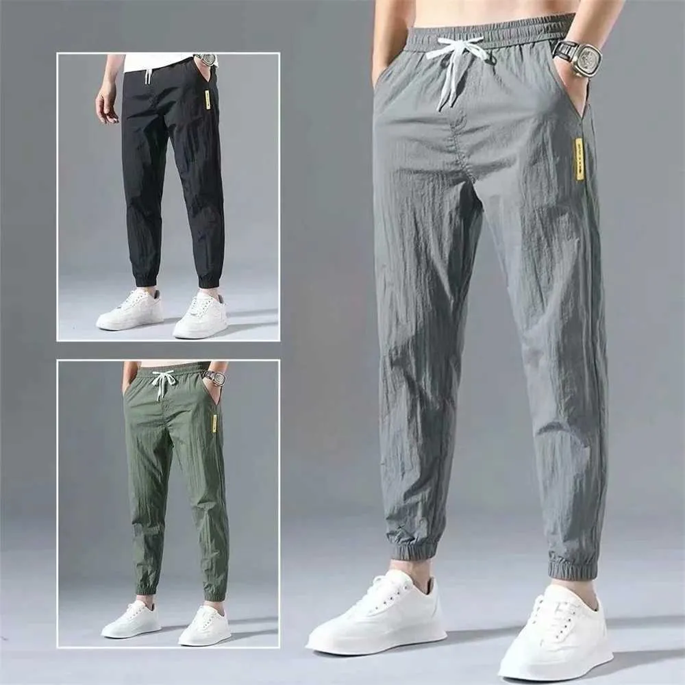 Mäns byxor Summer Mens Casual Sports Pants Polyester Korean Mens Ankle Tie Jogging Pants Breattable Solid Color Casual Pantsl2403