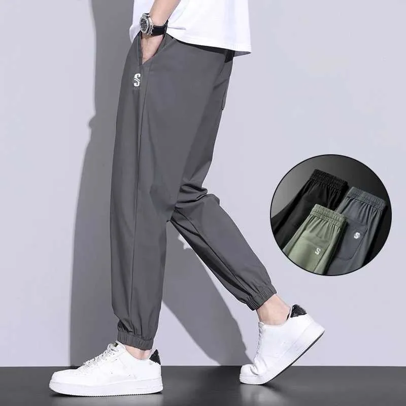 Pantalones para hombres nuevos pantalones de seda de hielo marca de moda para hombres corbata de pierna suelta deportes rápidos 2023 verano delgable corte transpirable pantalones casualesl2404