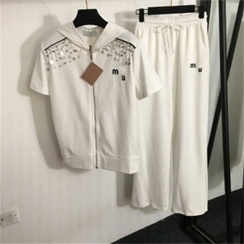 Summer Womens Tracksuit dwuczęściowy zestaw Kobiet Designer Suit cekin haftowany krótkoczestrowy z kapturem kurtka zamek z kapturem i elastyczne malejące spodni kobiet ubrania