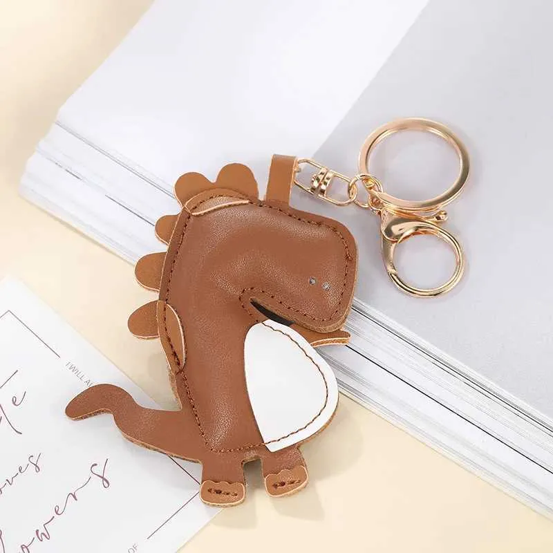 Keychains Bedanyards New Dinosaur Keychain PU Chaveton Keychains para mulheres Bolsa de bugigangas pingentes de bugigangas homens menses -chave do anel Chain Chain Gift Q240429