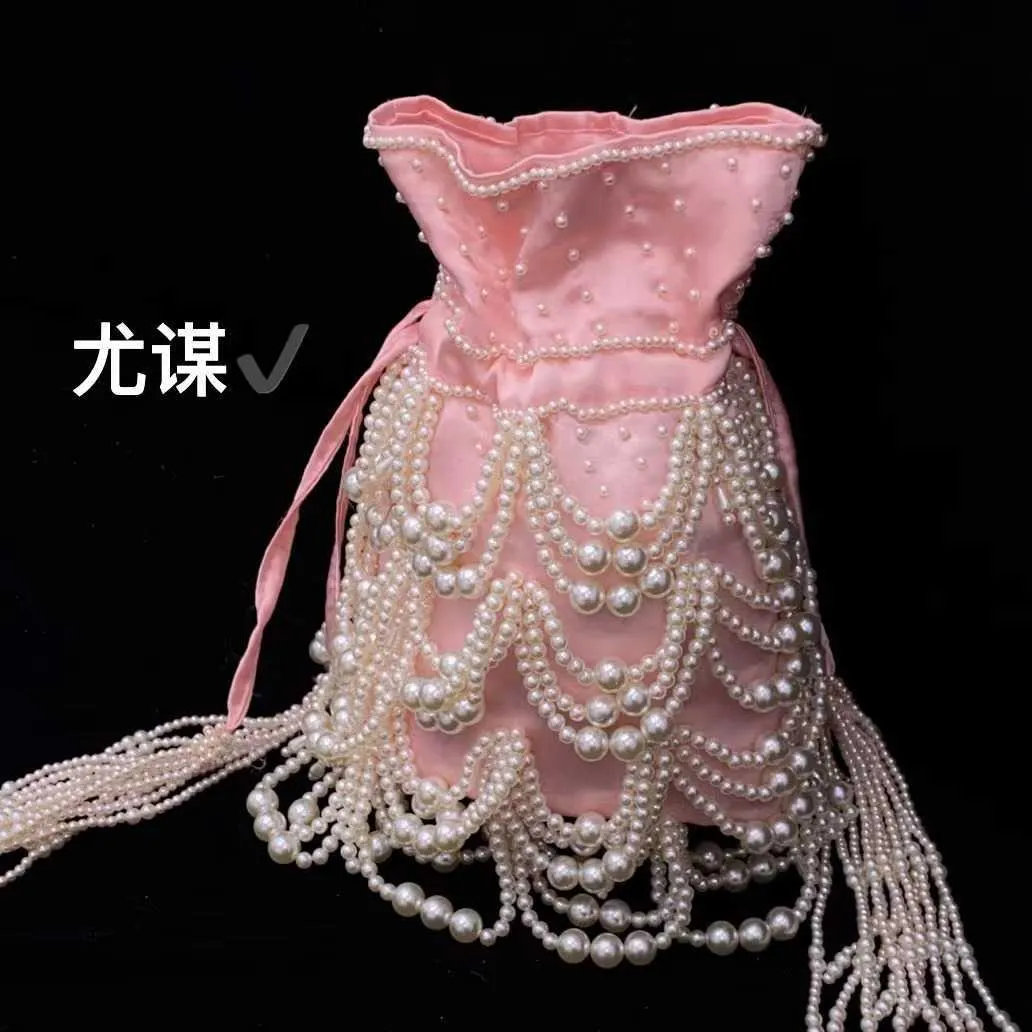 Famous socialite tassel pearl silk satin drawstring bucket heavy industry handmade woven beaded pearl carrying crossbody bag