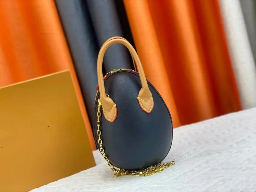 2024 Primavera / Estate Nuovo design di lusso Moda femminile Classico uovo di dinosauro con finiture in pelle di vacchetta e mini tracolla a catena Borsa a tracolla portatile