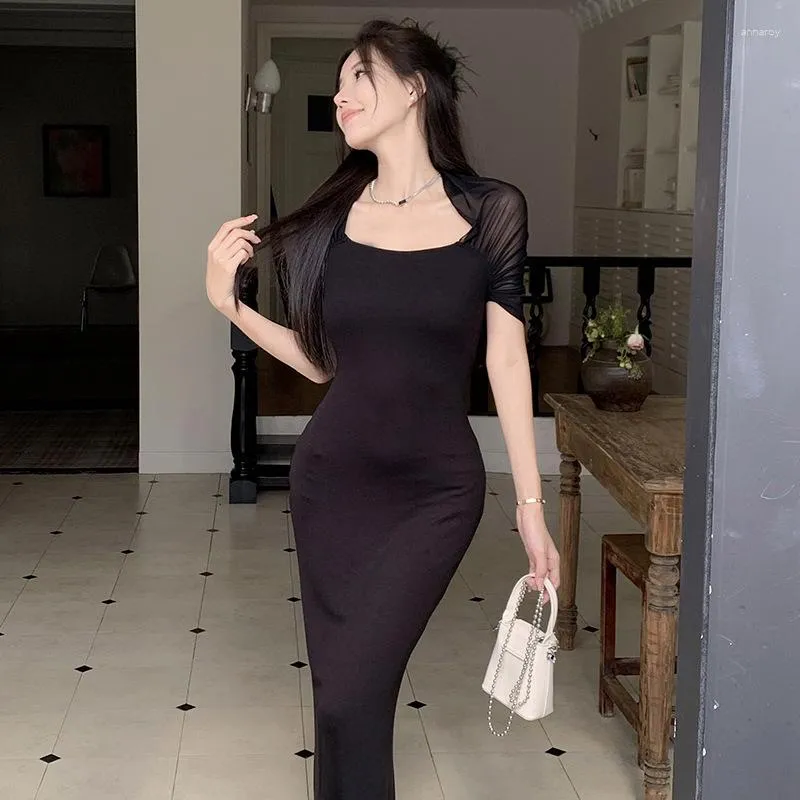 Elegant Black sleeveless evening gown with fitted silhouette and delicate overlay.