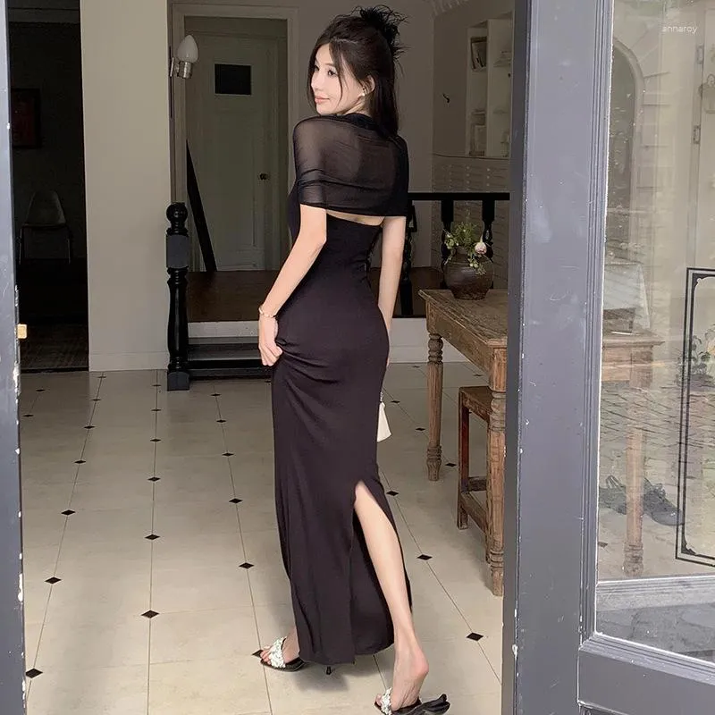 Elegant Black sleeveless evening gown with fitted silhouette and delicate overlay.