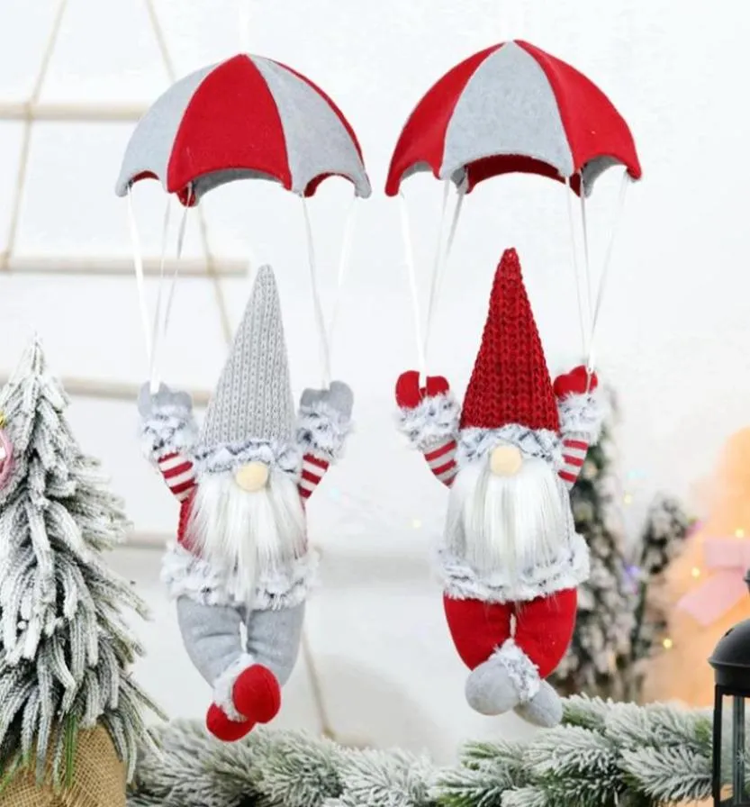Juldekorationer hängande hängande ornament fallskärm nissar år gåvor levererar grå rött par eldstad vägg hem3654737