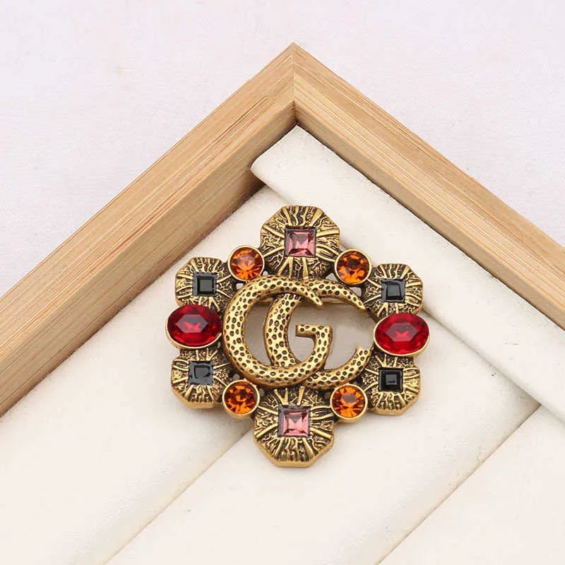 2023 New Luxury High Quality Fashion Jewelry for New hollowed out color diamond zircon inlaid Brooch anti light coat pin female