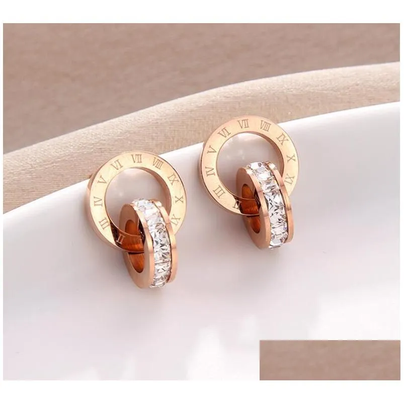 Stud Crystal Diamond Pendientes Oro rosa Moda Titanio Acero Doble herida Números romanos Studs Pendiente para niña Mujer Regalo Joyería Dhbhu