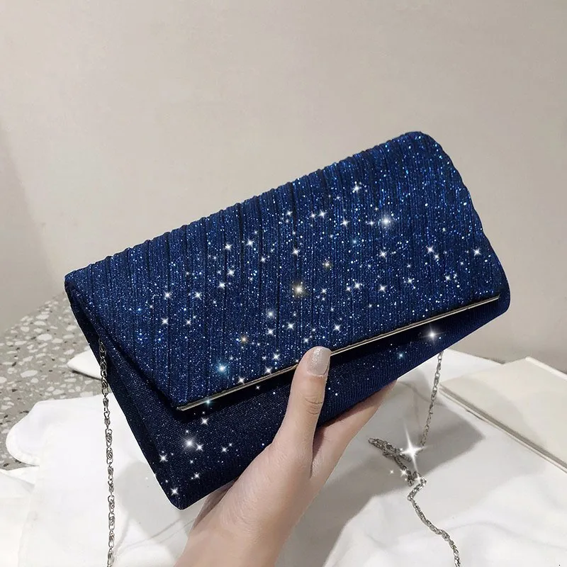 Navy and top silver clutch bags