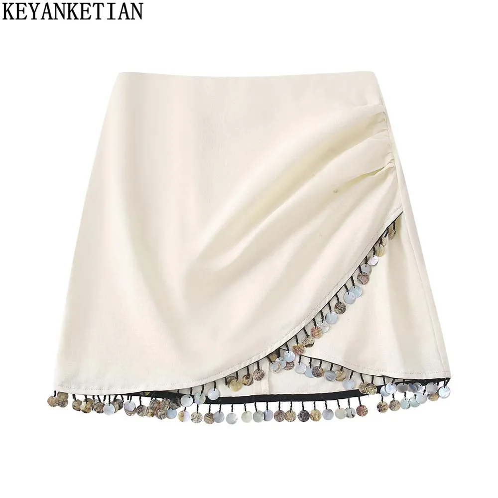 Capris Keyanket 2022 Été Nouvelle jupe de taille haute perlé élégant abricot asymétrique Aline Jupe Pack Hip Mini jupe
