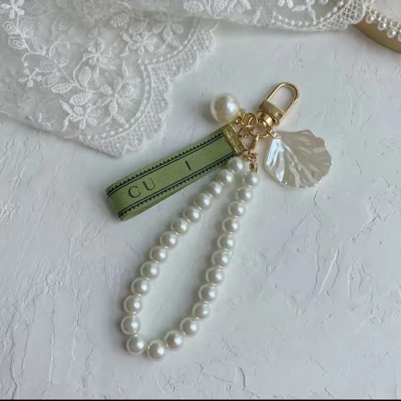 Designer Schlüsselbund Luxus Schlüsselkette Beutel Charme weiblicher Auto Key Ring Perle Charm Green Ribbon Zarte Schalen Schlüsselbund Paar Anhänger Geschenk Schöne Goodg0mi